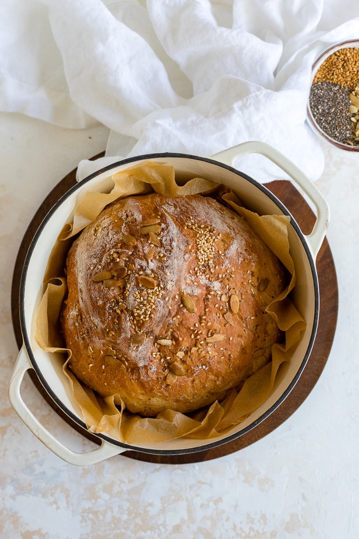 https://www.nourish-and-fete.com/wp-content/uploads/2018/12/no-knead-dutch-oven-bread-with-seeds-720px-1.jpg