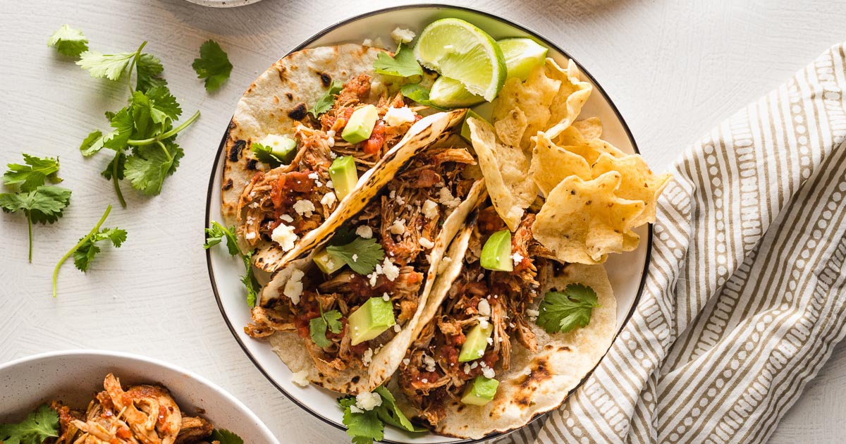 https://www.nourish-and-fete.com/wp-content/uploads/2021/11/crockpot-shredded-chicken-tacos-facebook.jpg