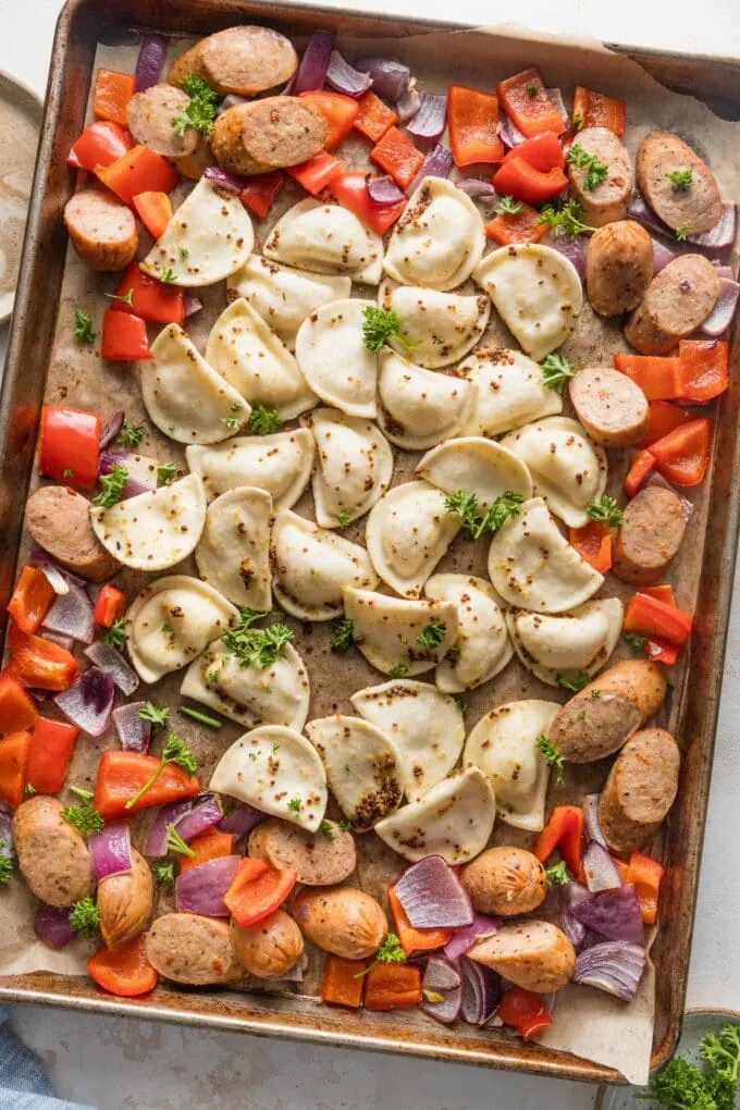 A variety of sheet pan recipes featuring chicken and vegetables, salmon, and healthy one pan meals with vibrant colors and fresh ingredients.
